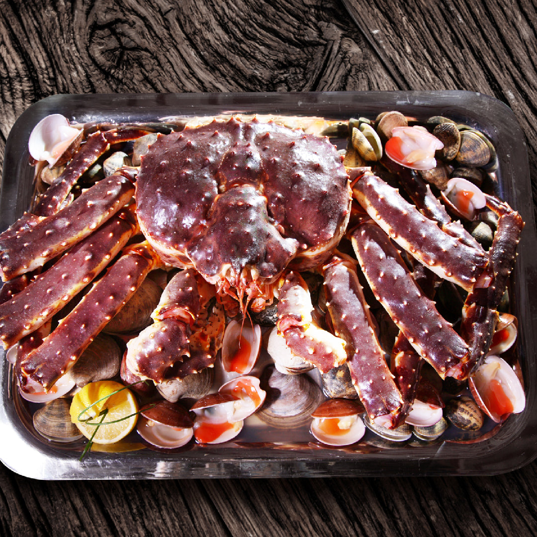 Alaskan king crab legs on ice at a seafood market with price tags, illustrating how to find the best king crab deals online and in-store