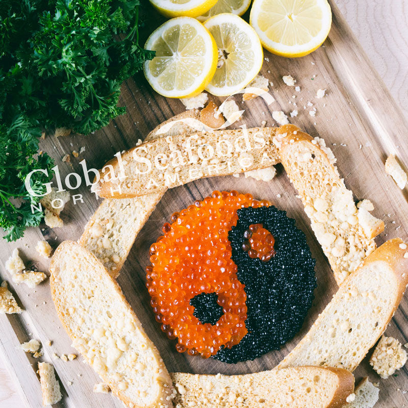 Elegant caviar pie topped with glistening salmon roe on a white serving platter with crackers