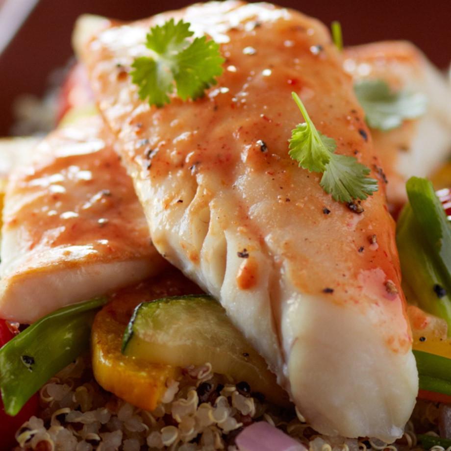 Baked Wild Alaskan Pollock fillet with roasted vegetables and quinoa on a plate