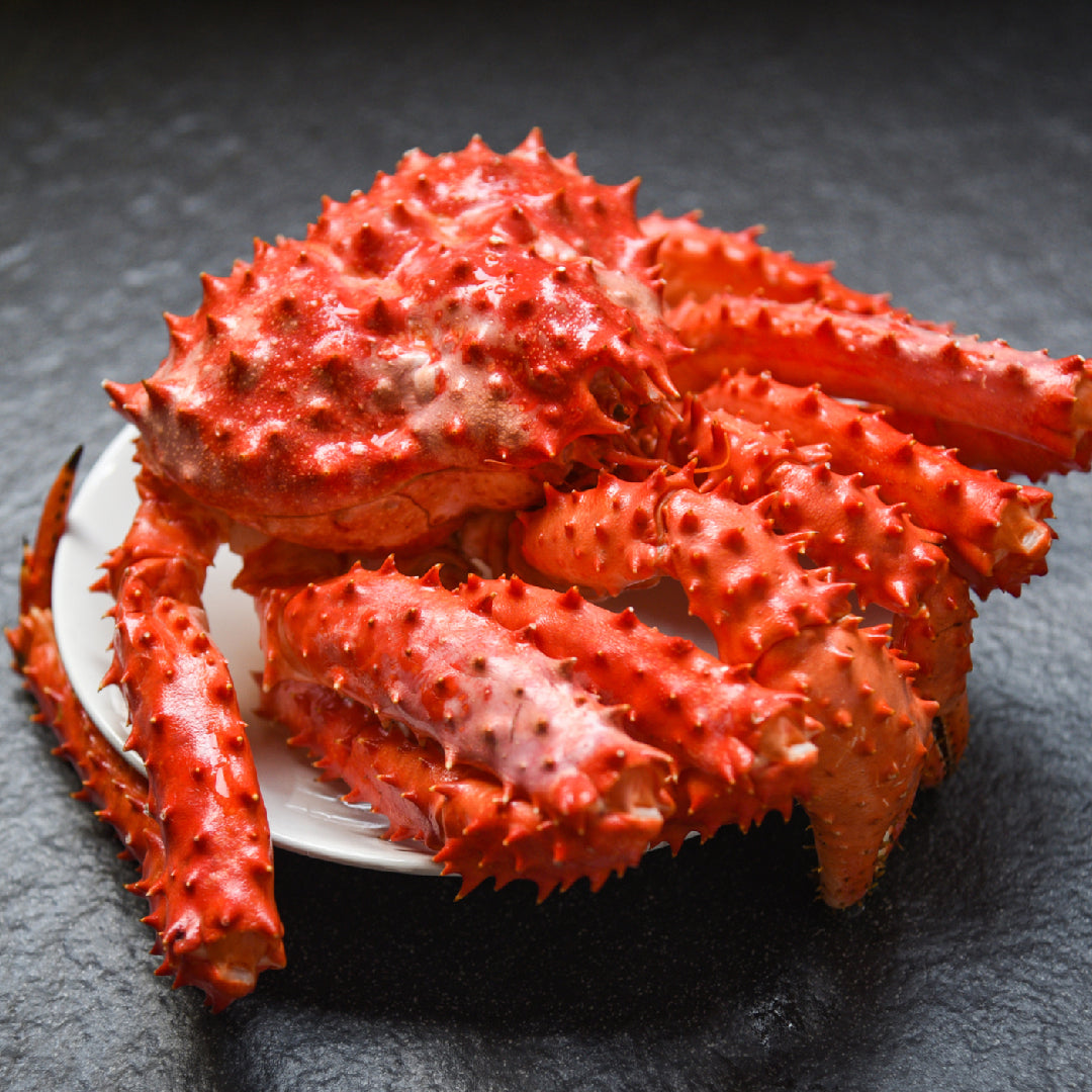 Alaskan king crab in its natural habitat on the ocean floor, representing sustainable wild-caught seafood practices