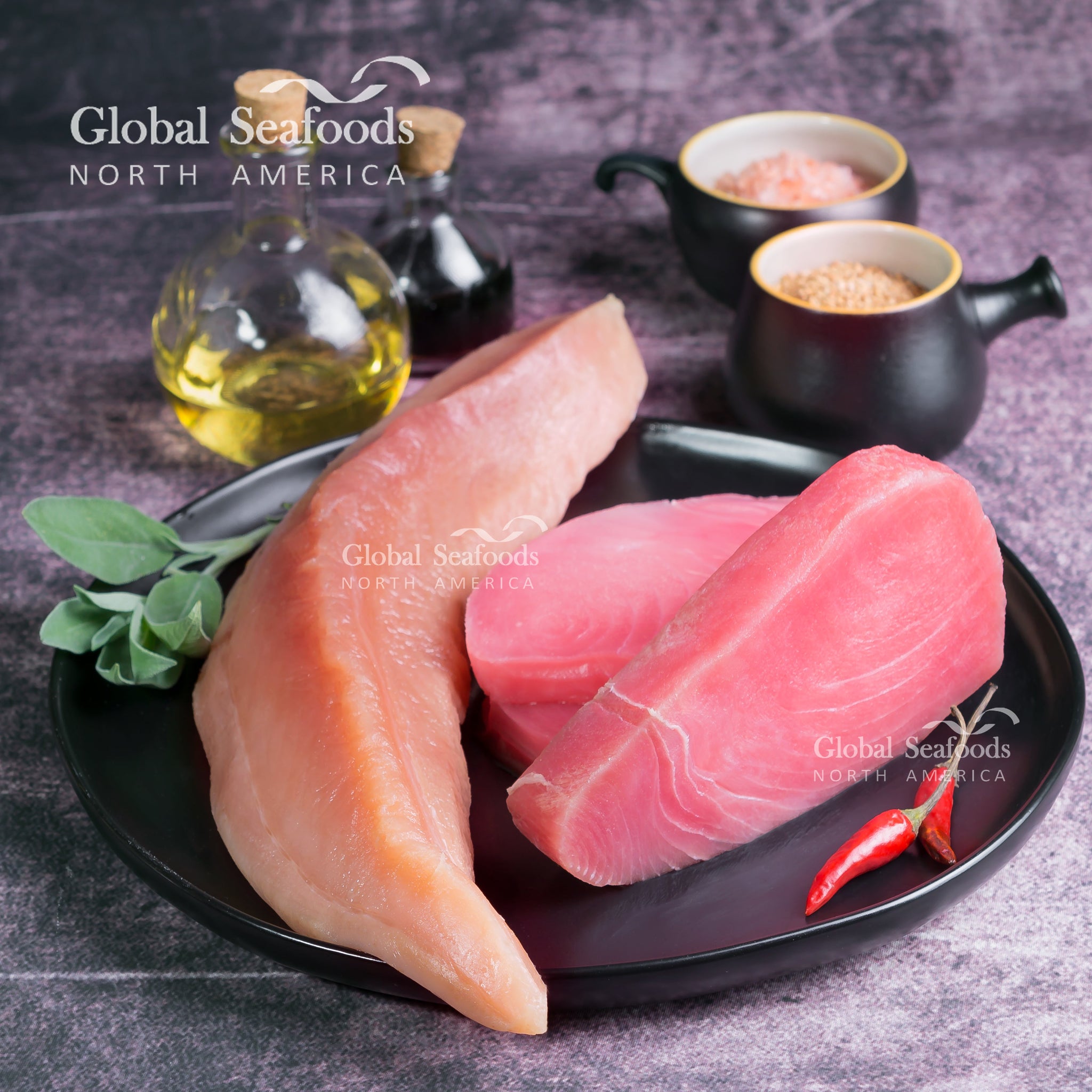 Sashimi-grade raw tuna steaks on cutting board, used for making tuna salami