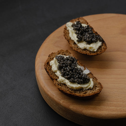 Beluga caviar pearls in a crystal dish on ice showcasing their large glossy appearance and luxurious texture