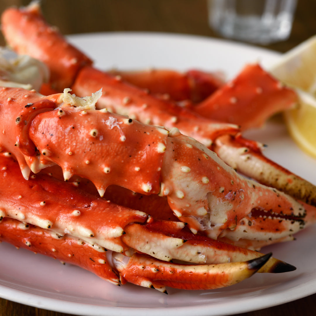 Assorted crab claws served with white wine and lemon on an elegant dinner table