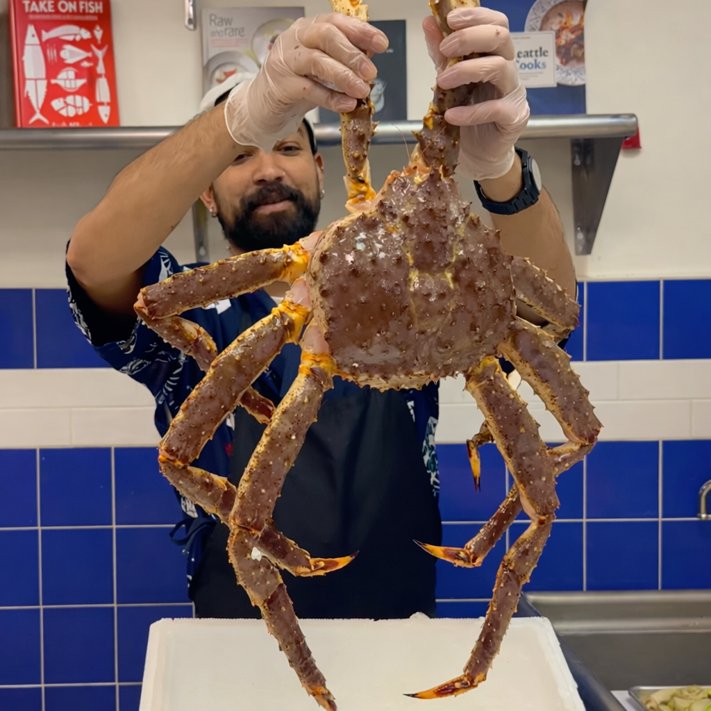 Fresh live King Crab on ice, ready to be steamed and served