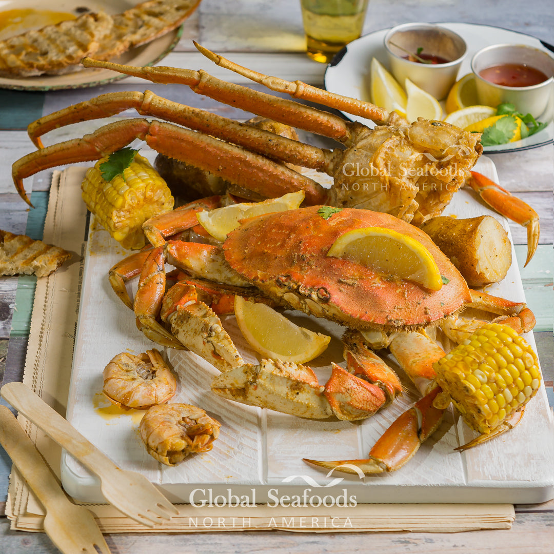 A large pot of Cajun seafood boil with crab legs, shrimp, corn, and potatoes
