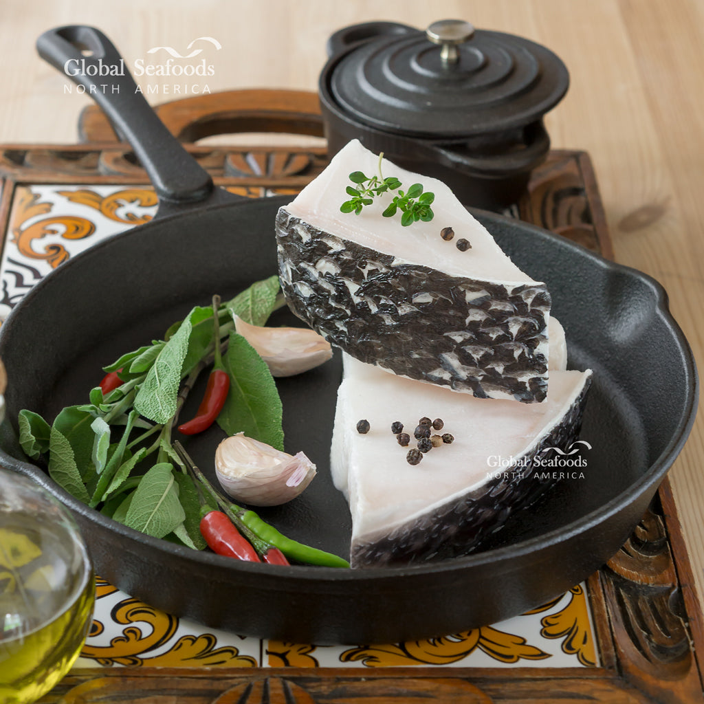 Miso-marinated Chilean sea bass fillet baked golden on parchment with scallion garnish