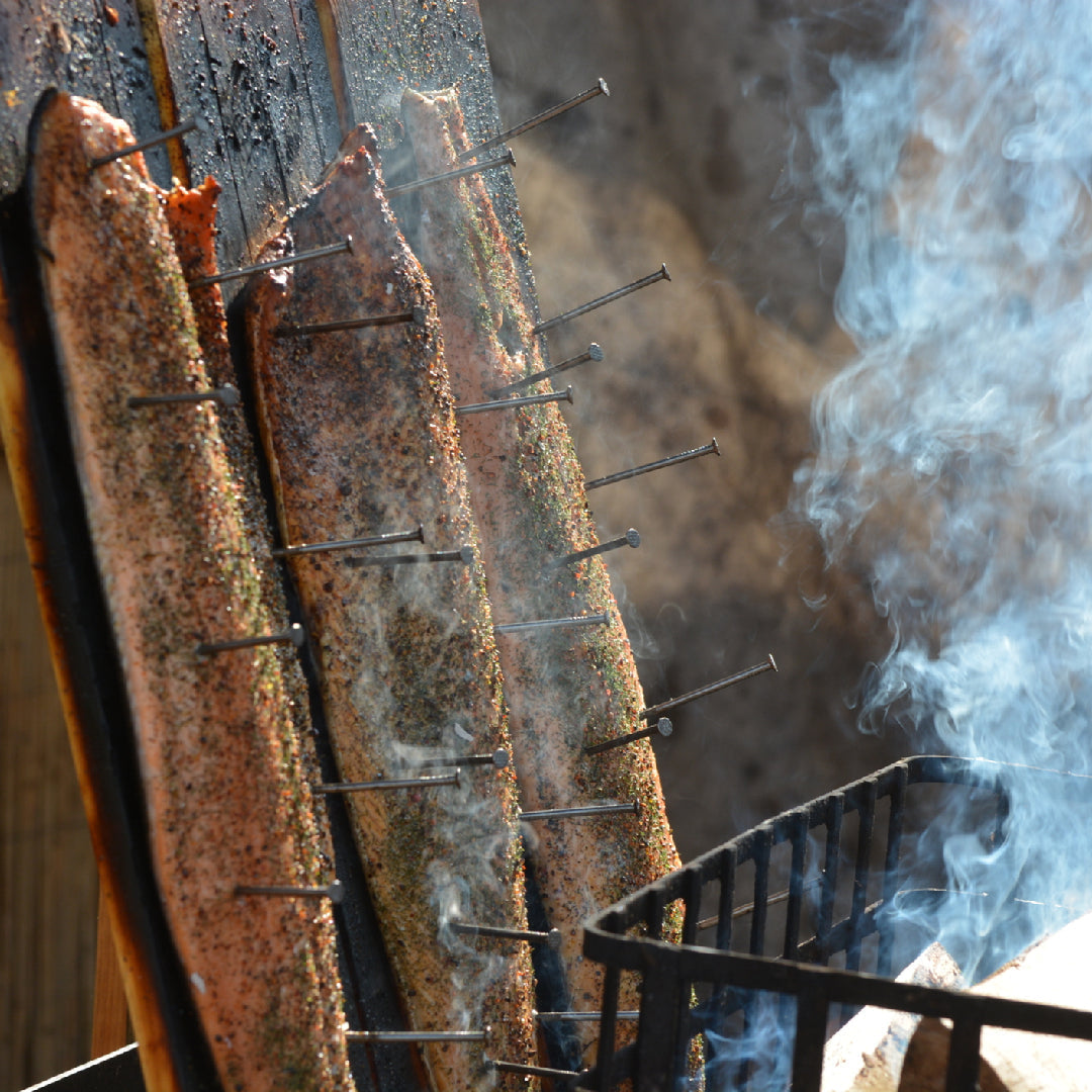 Homemade salmon candy — glazed, smoked sockeye salmon strips with a sweet maple and brown sugar crust on a wooden board