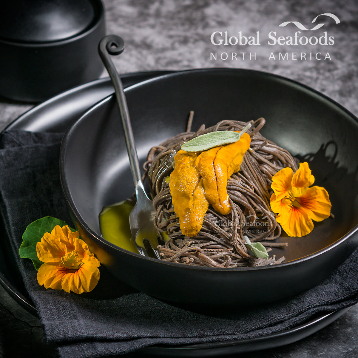 Fresh sea urchin uni roe displayed in its spiny shell with vibrant golden-orange color on a dark surface