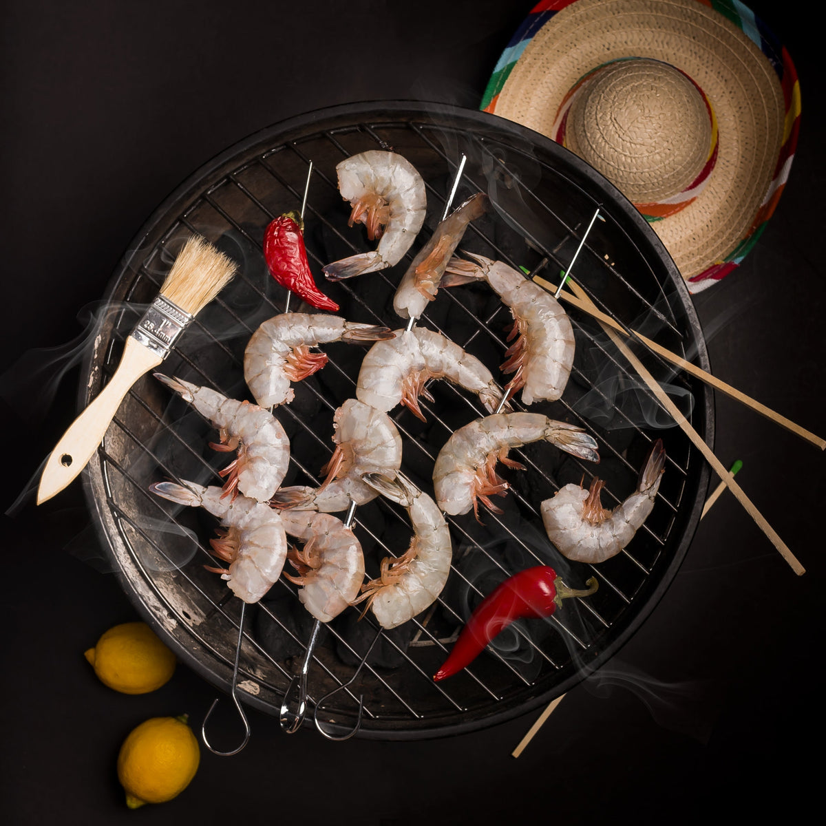 Plated shrimp pasta with Tom Yum sauce, garnished with fresh basil and asparagus tips, served in a white bowl