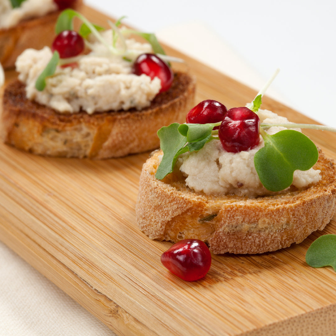 Four canned albacore tuna dishes arranged on a table: classic tuna salad, lemon caper pasta, tuna melt sandwich, and tuna avocado salad