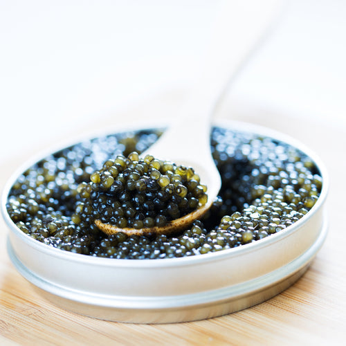 Kaluga caviar pearls served on a mother-of-pearl spoon over a bed of crushed ice