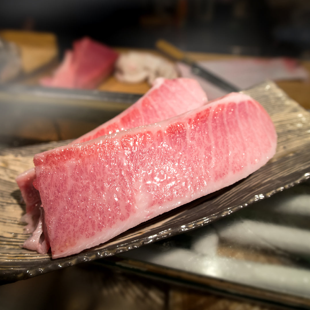 Bluefin tuna being unloaded at a fish market auction, highlighting the scale of commercial tuna fishing and sustainability concerns