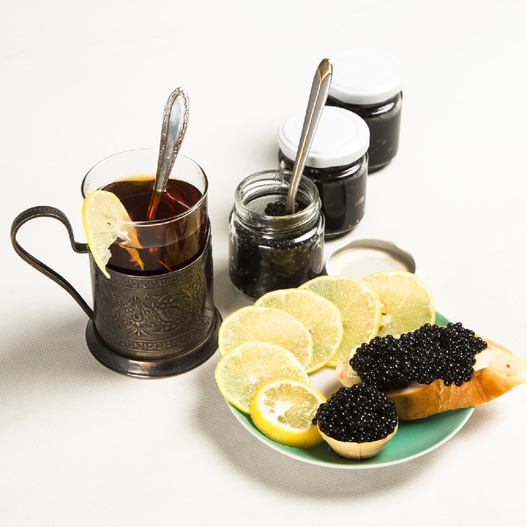 A tin of Osetra sturgeon caviar with a mother-of-pearl spoon — the most complex and nuanced of the sturgeon caviars, with a nutty, buttery finish that is the benchmark against which all other caviar is measured
