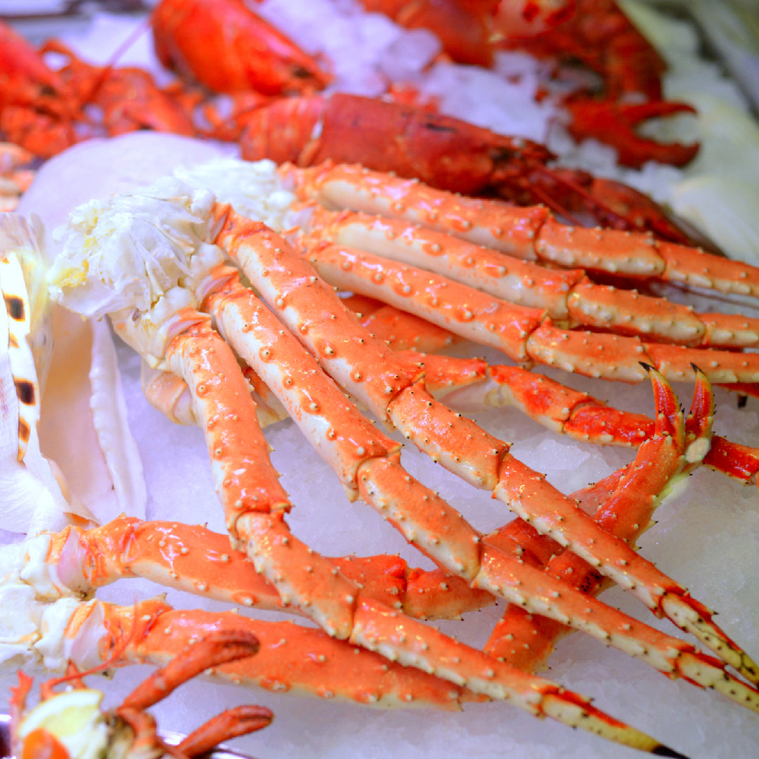 Five healthy crab claw dishes including steamed crab claws with lemon, crab salad with avocado, and crab lettuce wraps arranged on a light background