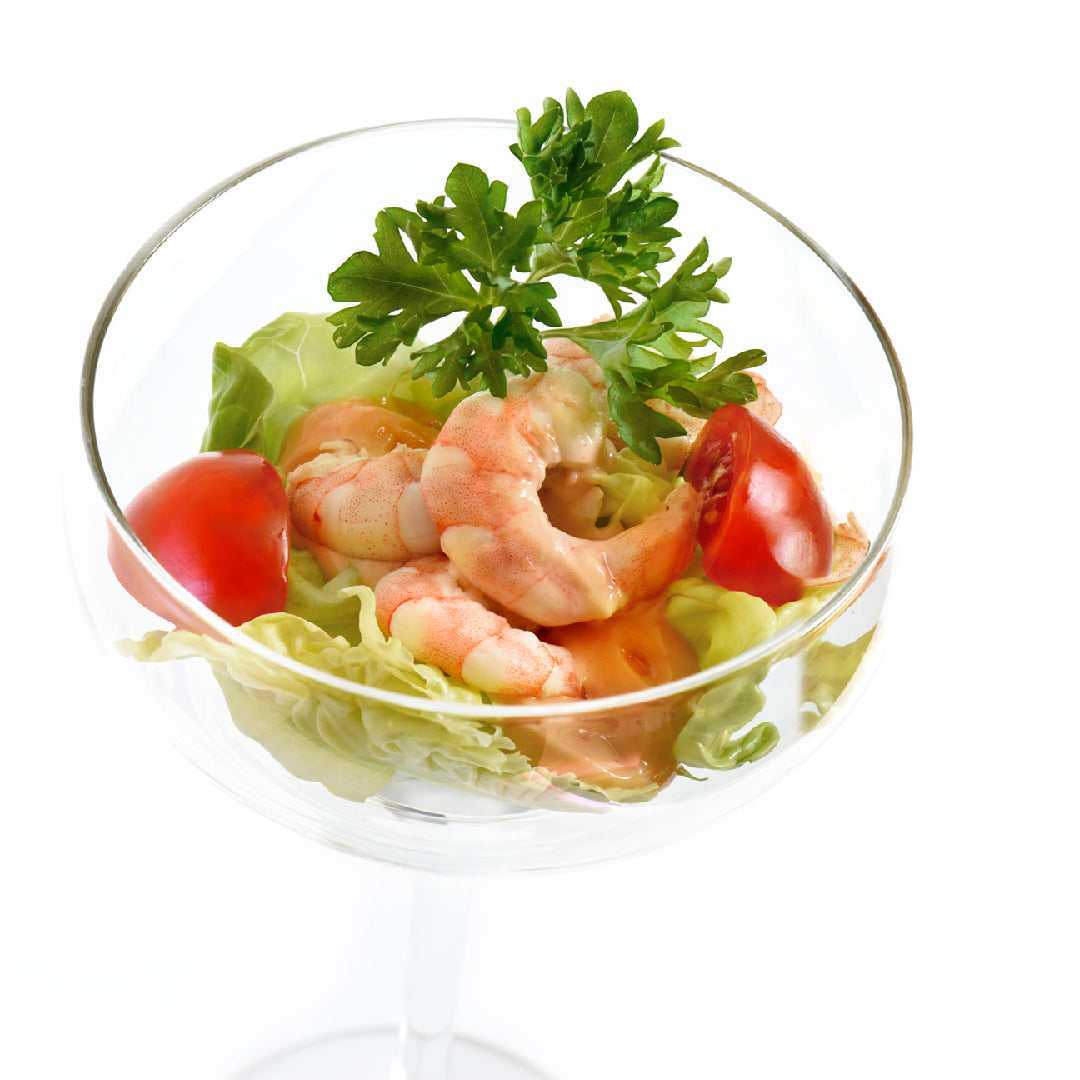Classic crab cocktail with cocktail sauce, lemon wedges, and fresh crab meat