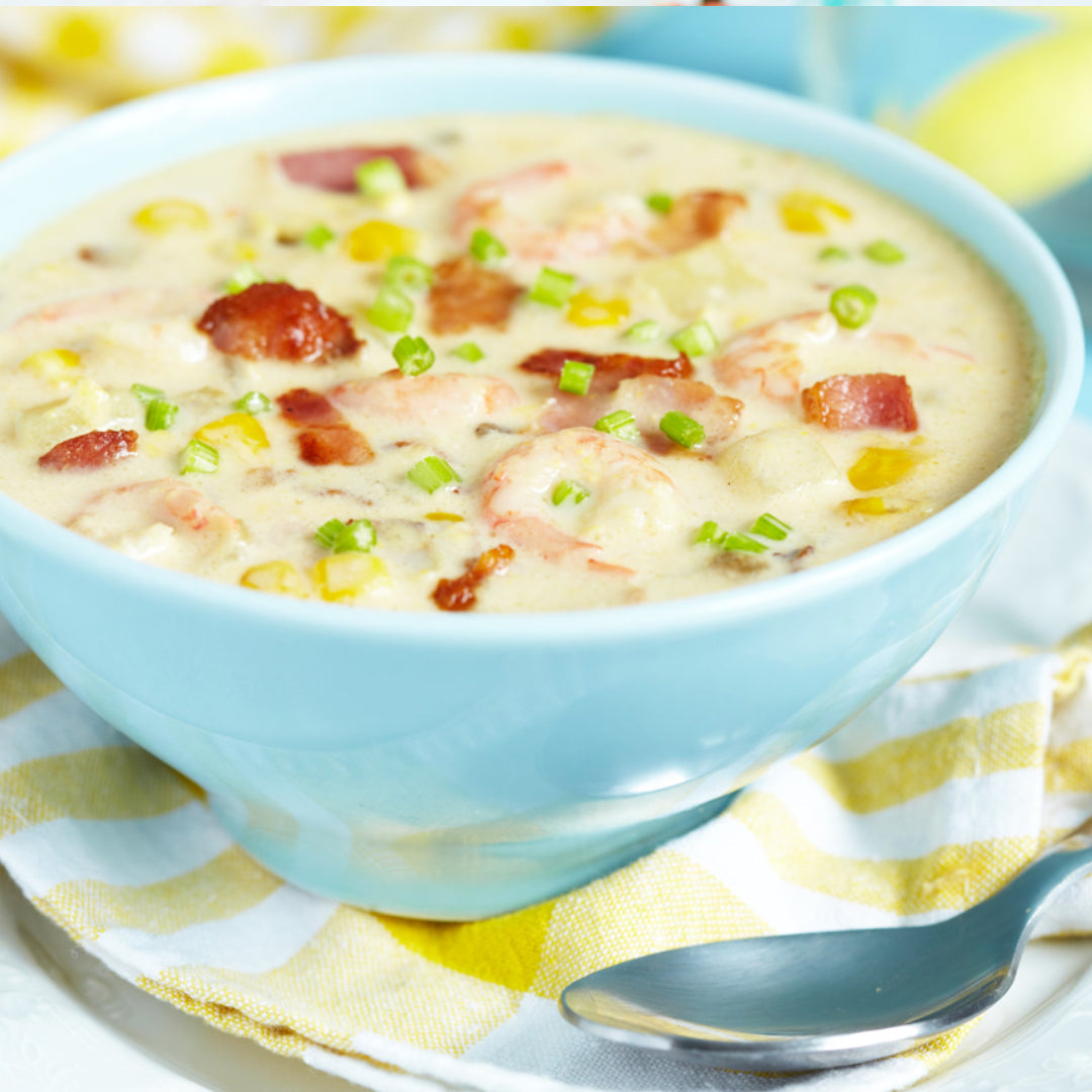 Creamy Dungeness crab and corn chowder served in a bowl with crusty bread