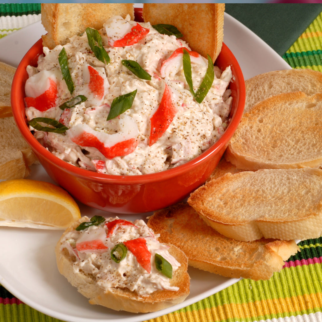 Creamy baked crab dip served with crackers and fresh parsley