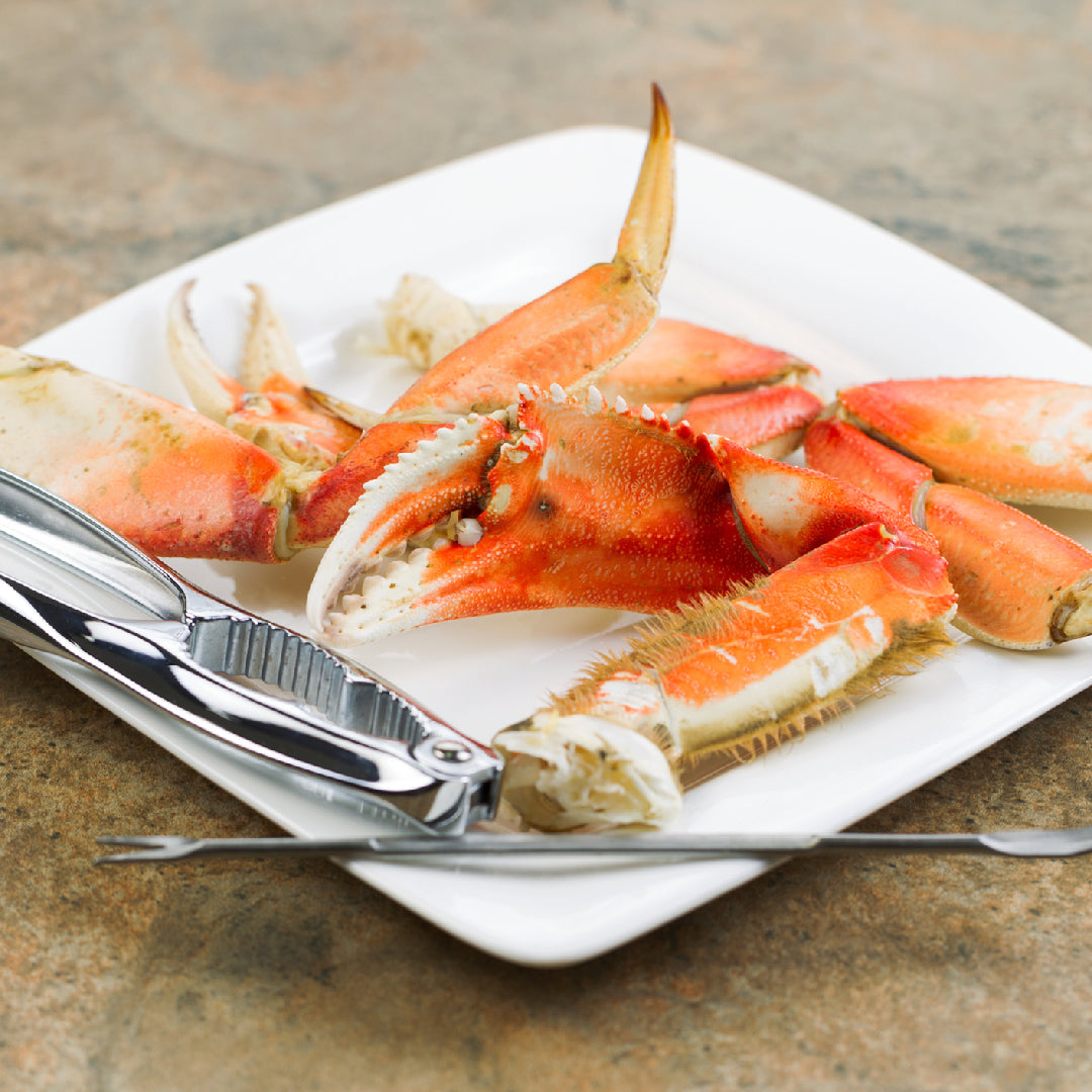 Plate of cooked Dungeness crab on a wooden table