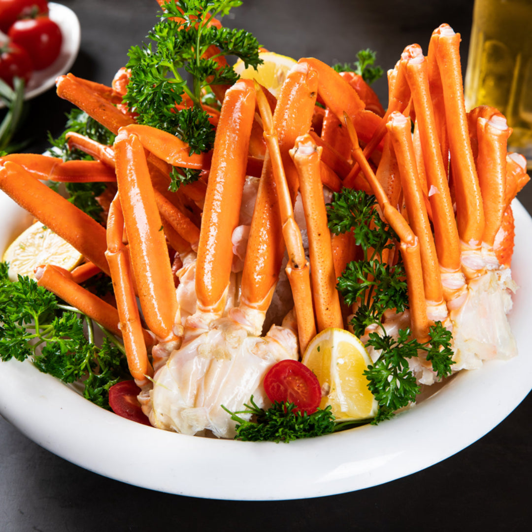 Frozen crab leg clusters on a plate, showing the bright orange shell and thick meaty legs
