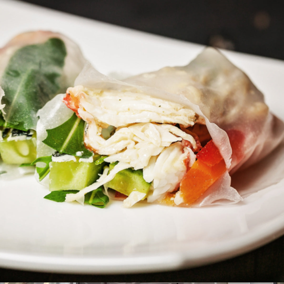 Crispy crab spring rolls filled with Dungeness crab meat and fresh vegetables on a serving plate