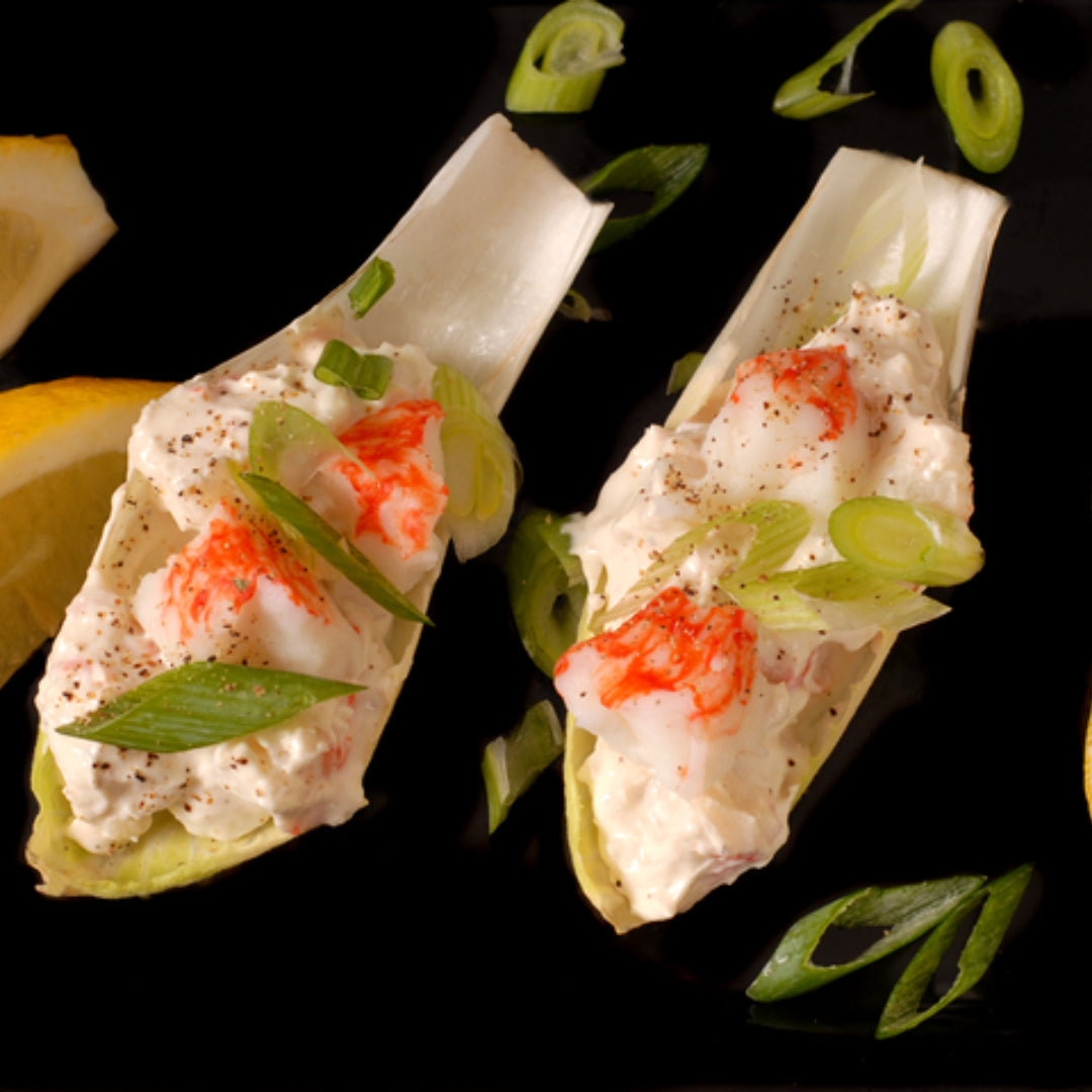 Keto snow crab salad served on lettuce leaves with lemon wedge and fresh parsley