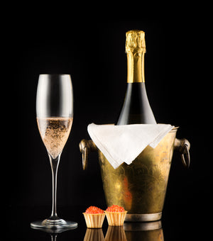 An elegant setup showcasing red caviar served in a crystal dish alongside a chilled flute of premium champagne, capturing the essence of luxury dining and the perfect pairing of these two gourmet delicacies