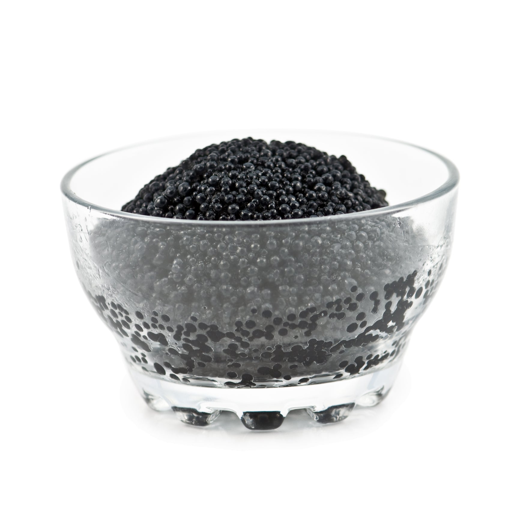 Elegant black caviar served on blinis with crème fraîche and fresh dill on a marble surface