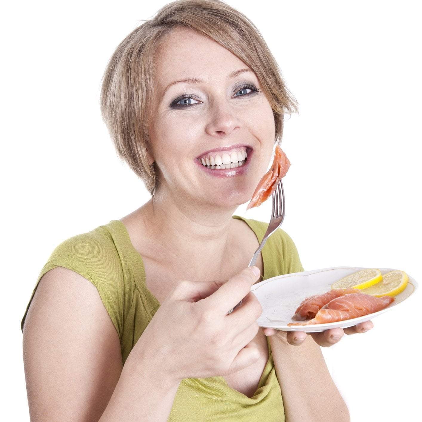 Variety of pregnancy-safe seafood options including cooked salmon, tilapia, and shrimp displayed on a well-arranged dining table