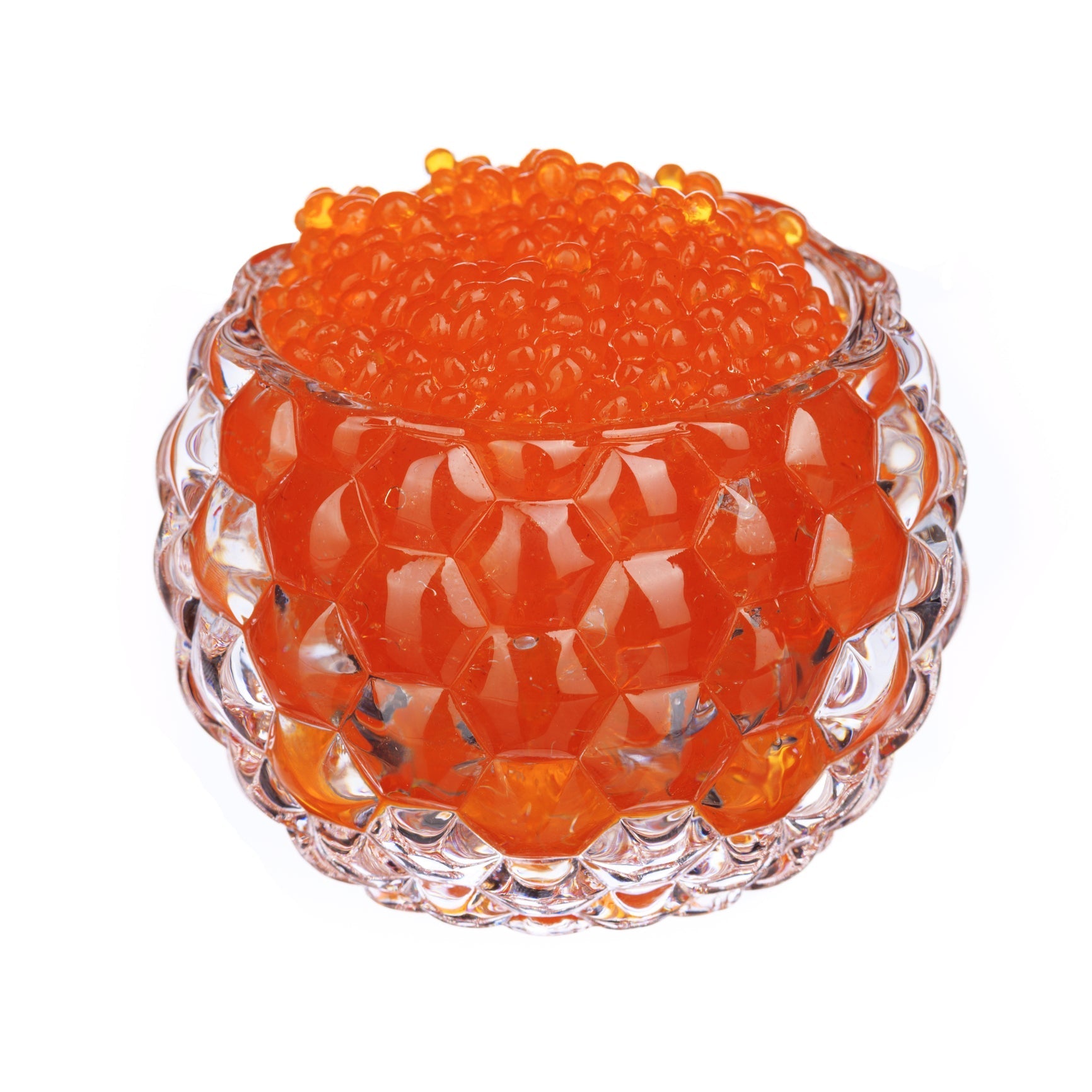 Close-up of fresh bright orange salmon roe eggs in a glass bowl, showing vibrant color and firm texture