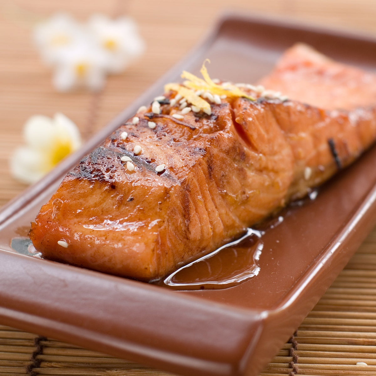 Fresh wild salmon fillet on ice with a food safety warning concept, illustrating the risks and precautions for raw salmon consumption
