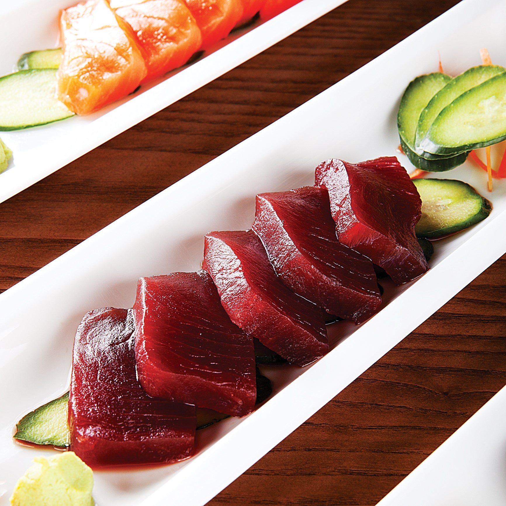 Ahi tuna poke bowl with avocado, edamame, pickled ginger, and sesame seeds on sushi rice