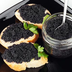Assortment of black caviar varieties in elegant serving dishes, highlighting the luxurious textures and colors from deep grey to rich black, embodying gourmet sophistication