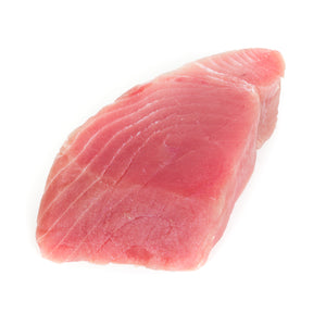 Fresh tuna steak on a cutting board, ready for preparation