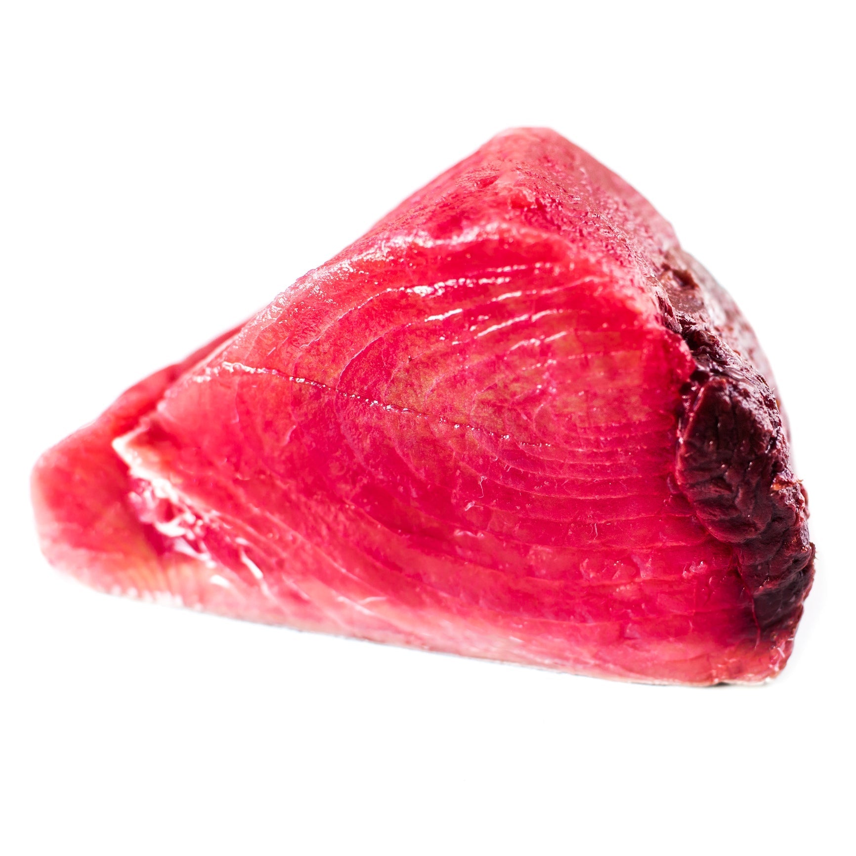 Fresh Ahi Tuna steaks stored on ice in a refrigerator tray, ready for cooking or sushi preparation