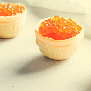 Salmon roe elegantly garnishing a freshly baked tart, adding a pop of color and gourmet flavor