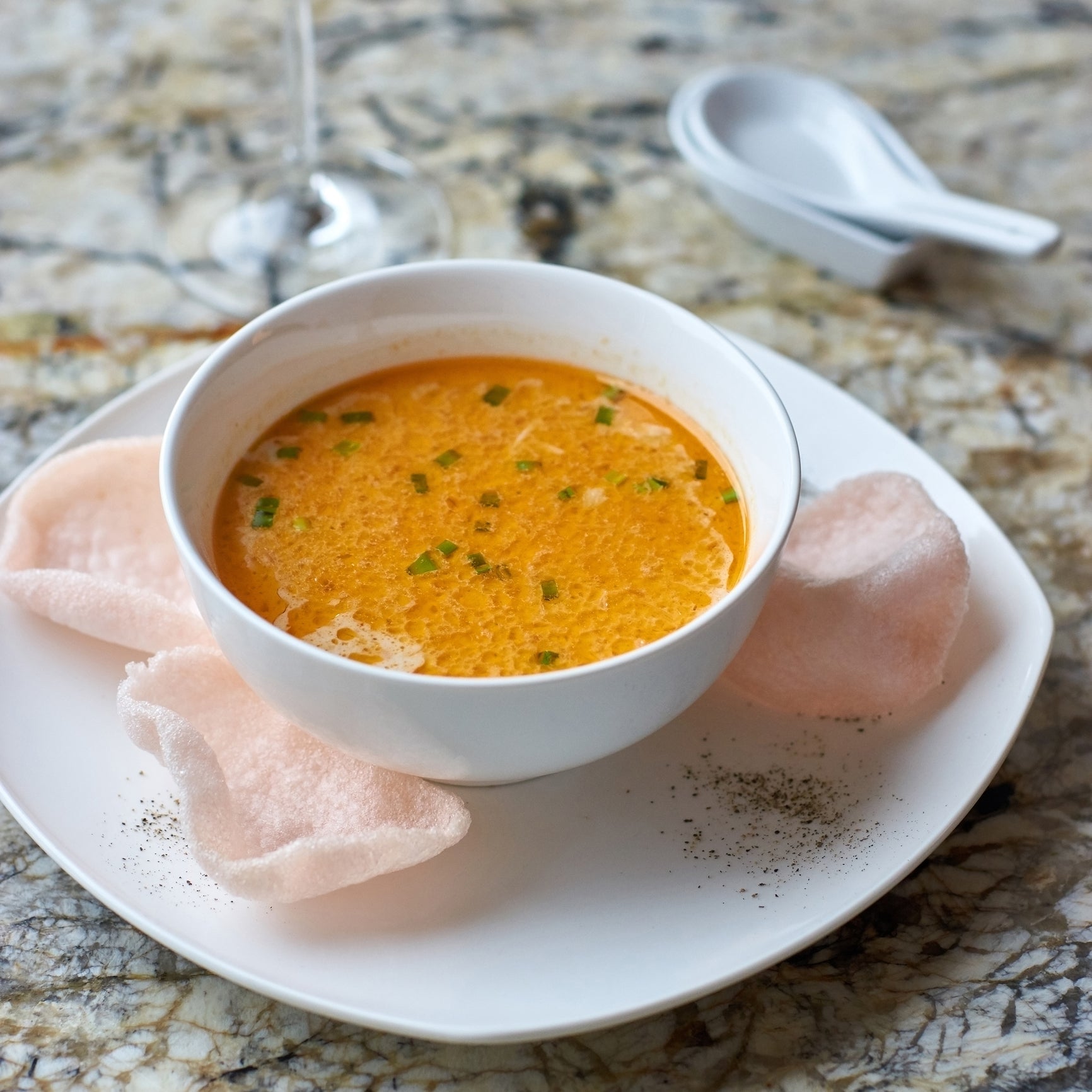 Three bowls of crab soup – creamy bisque, spicy Maryland-style, and Asian crab and corn soup – garnished with fresh herbs