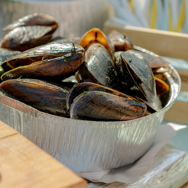 Fresh mussels being prepared for cooking