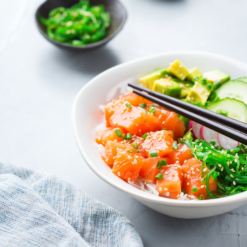 Fresh poke tuna bowl with cubed ahi tuna, avocado, cucumber, seaweed, and sesame seeds over rice