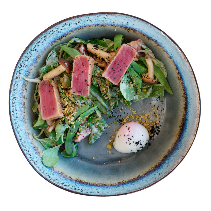 Family preparing smoked tuna tacos together in a bright kitchen