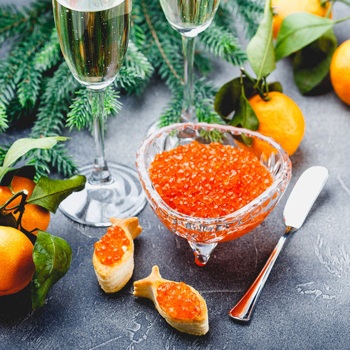 Fresh salmon roe being processed and packed into jars at a seafood facility