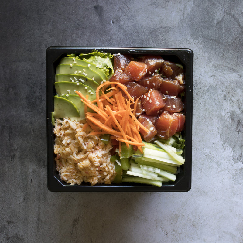 Fresh poke tuna bowl with cubed ahi tuna, avocado, edamame, cucumber, and sesame seeds over steamed rice