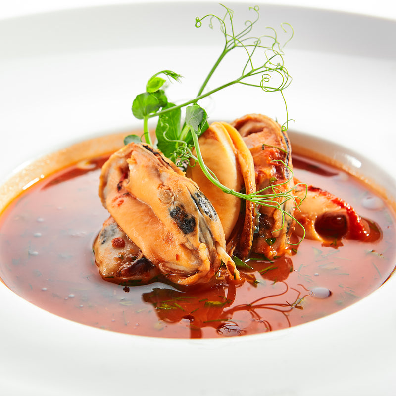 Steamed mussels in white wine and garlic broth served with crusty bread