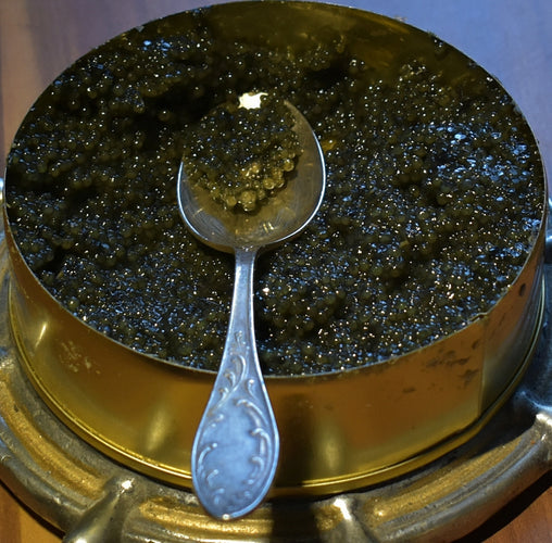Premium black caviar served on a mother-of-pearl spoon over crushed ice