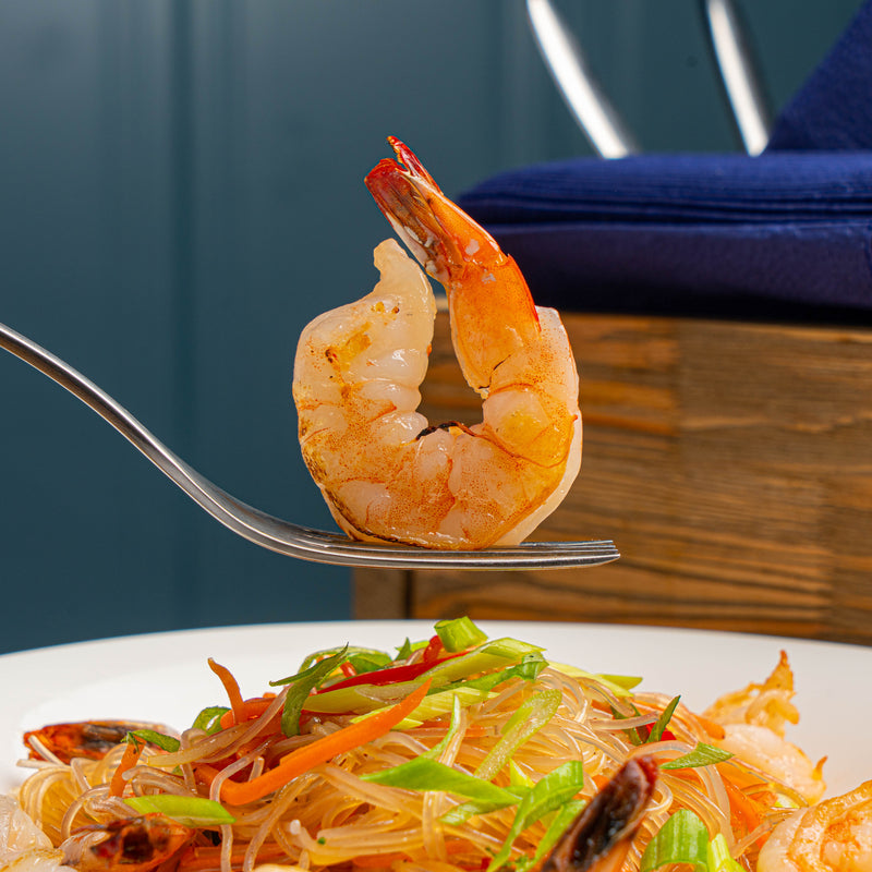 Plate of homemade shrimp scampi served over linguine with a garnish of parsley and a slice of lemon, symbolizing a classic seafood pasta dish