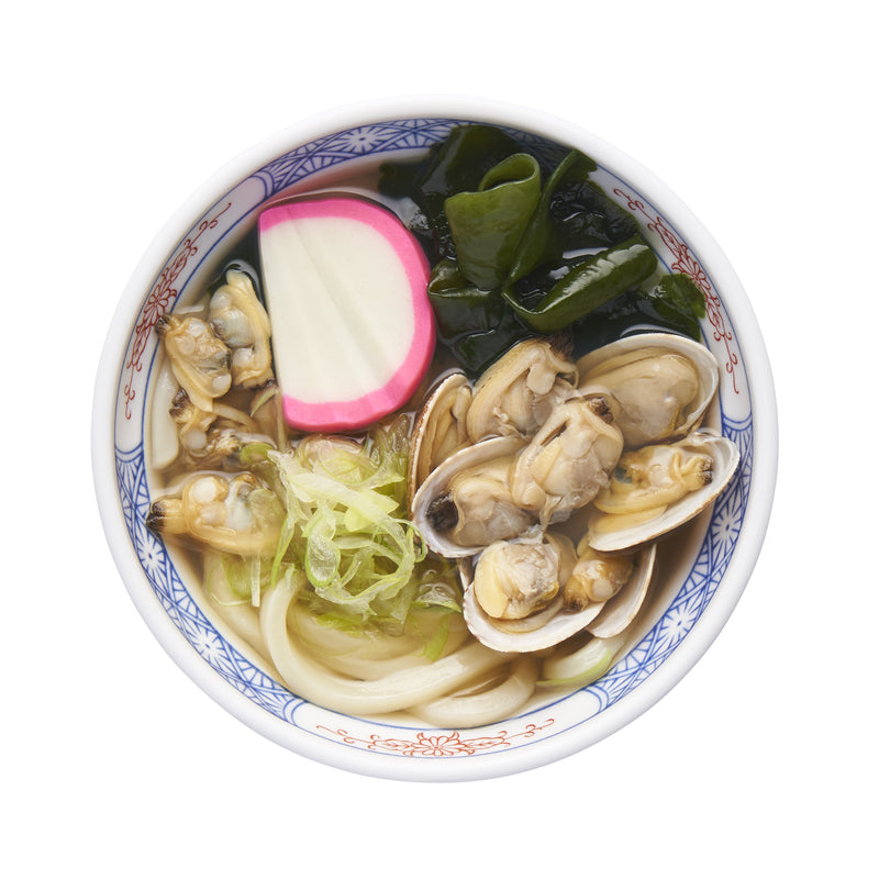 A variety of fresh Washington State clams including geoduck, razor clams, and Manila clams arranged on a bed of ice — showcasing the diverse bivalve species found in Washington's coastal waters
