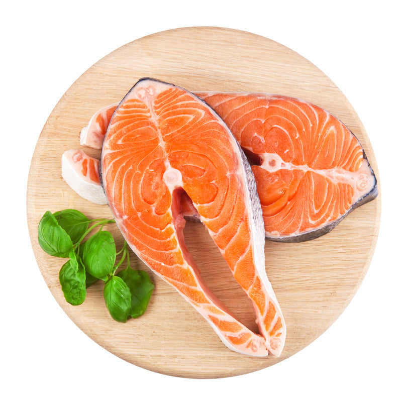 Close-up of fresh salmon fillet on ice at a seafood market counter