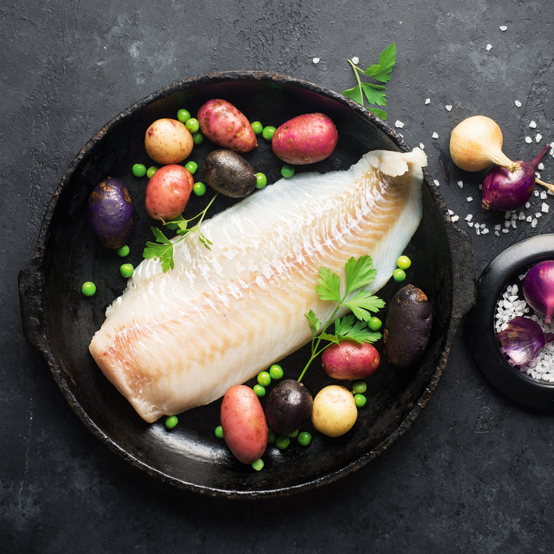 Fresh lingcod fillet with herbs and lemon