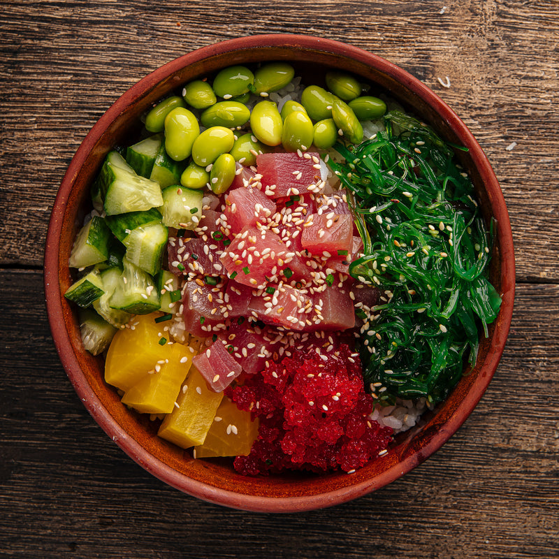 Five colorful poke tuna bowl variations including traditional Hawaiian, spicy, shoyu, wasabi, and fruit-infused styles