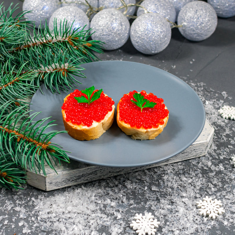 Salmon roe preparations from around the world -- Japanese ikura gunkan-maki, Russian blini with red caviar, and Scandinavian salmon roe on crispbread