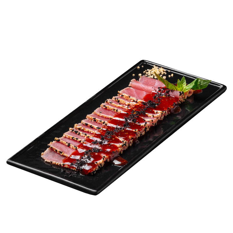 Platter of smoked tuna crostini and avocado canapés garnished with fresh dill
